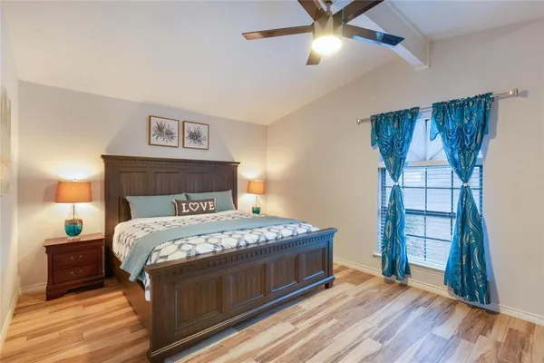 a bedroom with a bed and a window