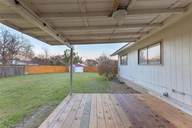 a view of a backyard with wooden floor
