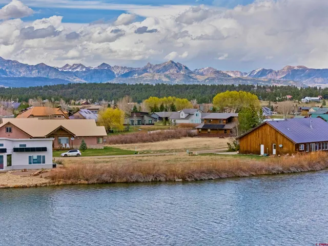an aerial view of residential houses and lake view