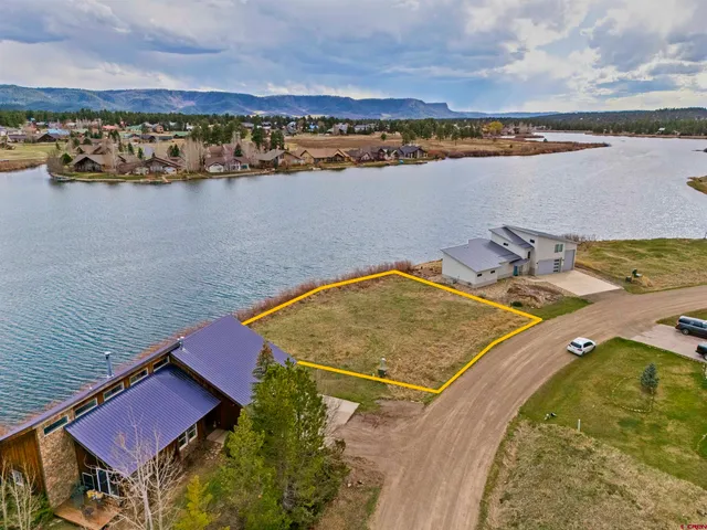 an aerial view of a house with a lake view