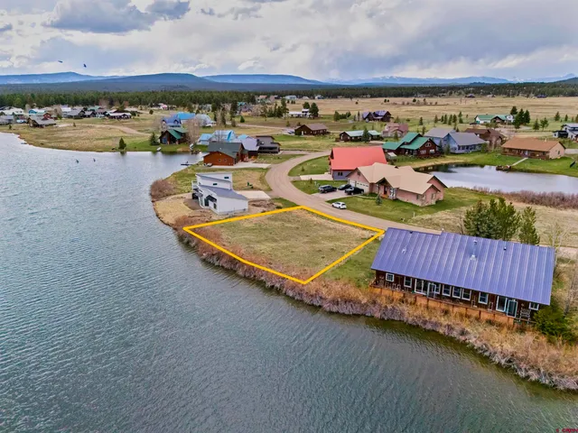an aerial view of a house with a ocean view