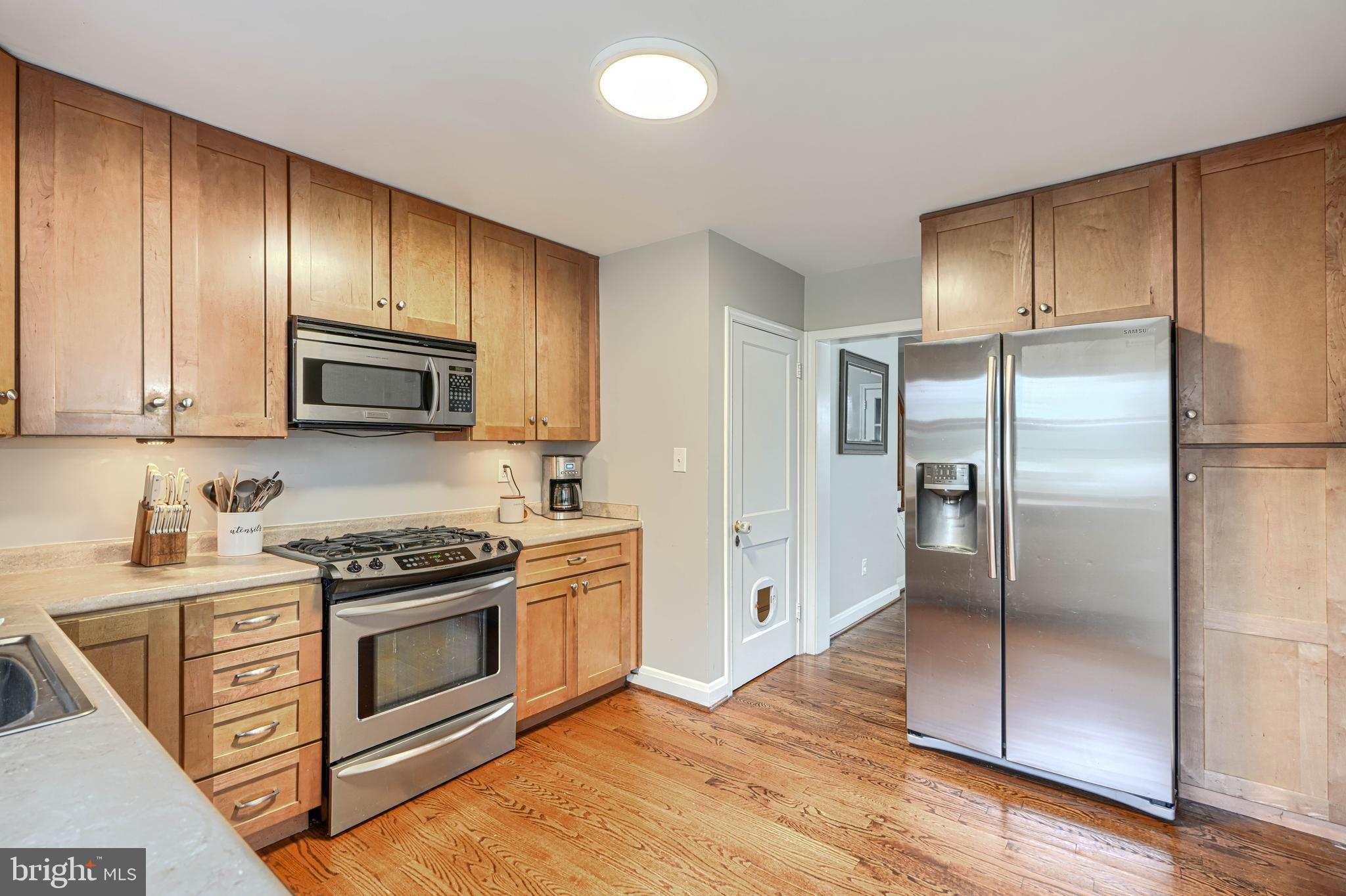 8132 Pleasant Plains Road Towson, MD 21286 - Photo 16 of 55 a kitchen with granite countertop wooden cabinets stainless steel appliances and a granite counter tops