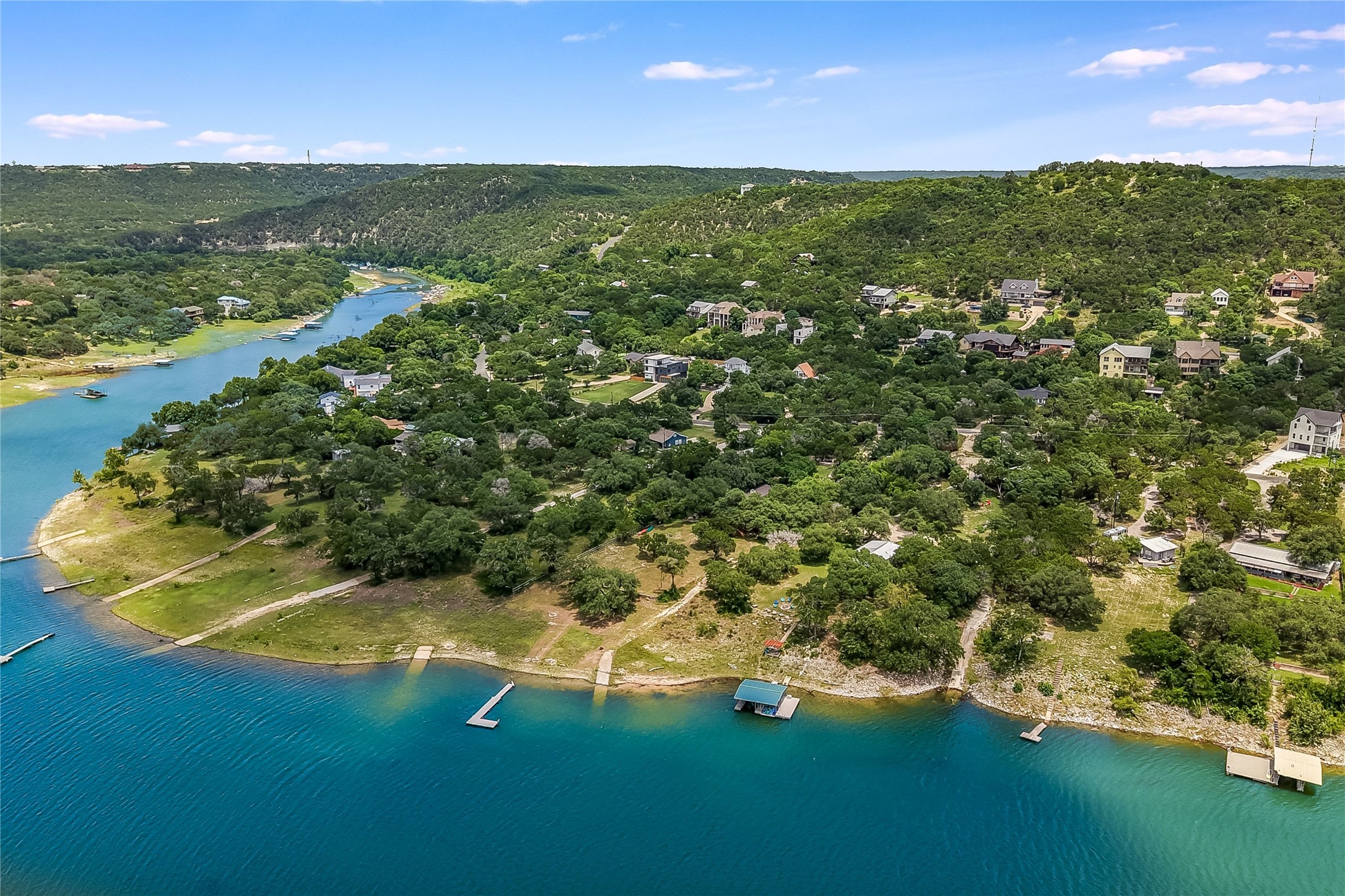 A tranquil lakeside community with private docks dotting the vibrant blue water.