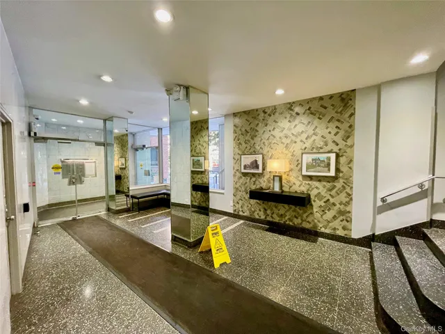 a lobby with furniture and a rug