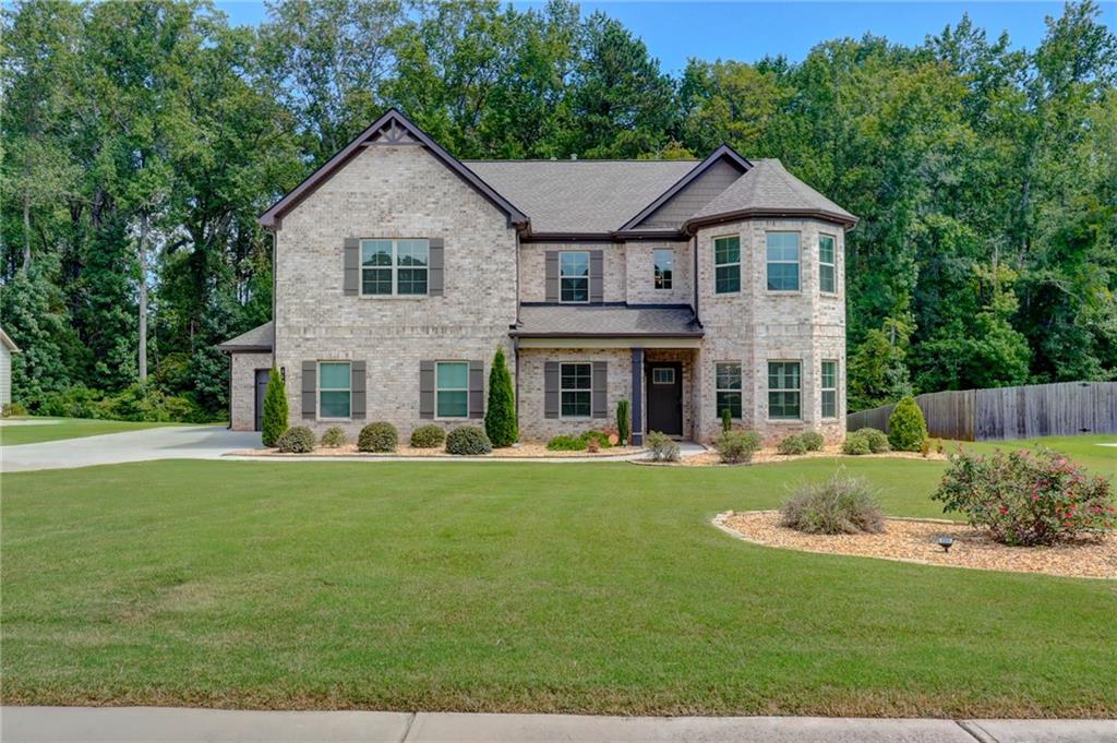 a front view of a house with a yard