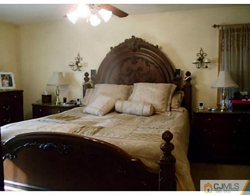 435 Crows Mill Road Fords, NJ 08863 - Photo 11 of 24 a bedroom with a bed and a mirror