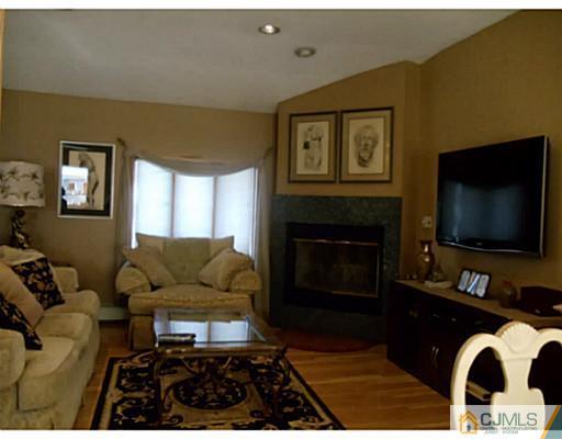 435 Crows Mill Road Fords, NJ 08863 - Photo 13 of 24 a living room with furniture and a fireplace
