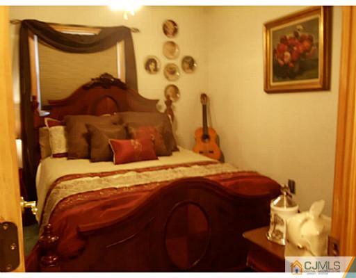 435 Crows Mill Road Fords, NJ 08863 - Photo 16 of 24 a bedroom with a bed and a painting on the wall