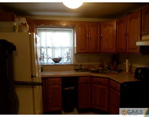 435 Crows Mill Road Fords, NJ 08863 - Photo 19 of 24 a kitchen with a sink a window and cabinets