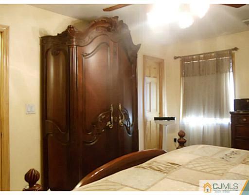 435 Crows Mill Road Fords, NJ 08863 - Photo 24 of 24 a bedroom with a bed and a mirror