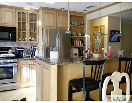 435 Crows Mill Road Fords, NJ 08863 - Photo 10 of 24 a kitchen with stainless steel appliances granite countertop a stove and a refrigerator