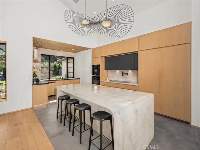 a view of a dining room with furniture and a chandelier