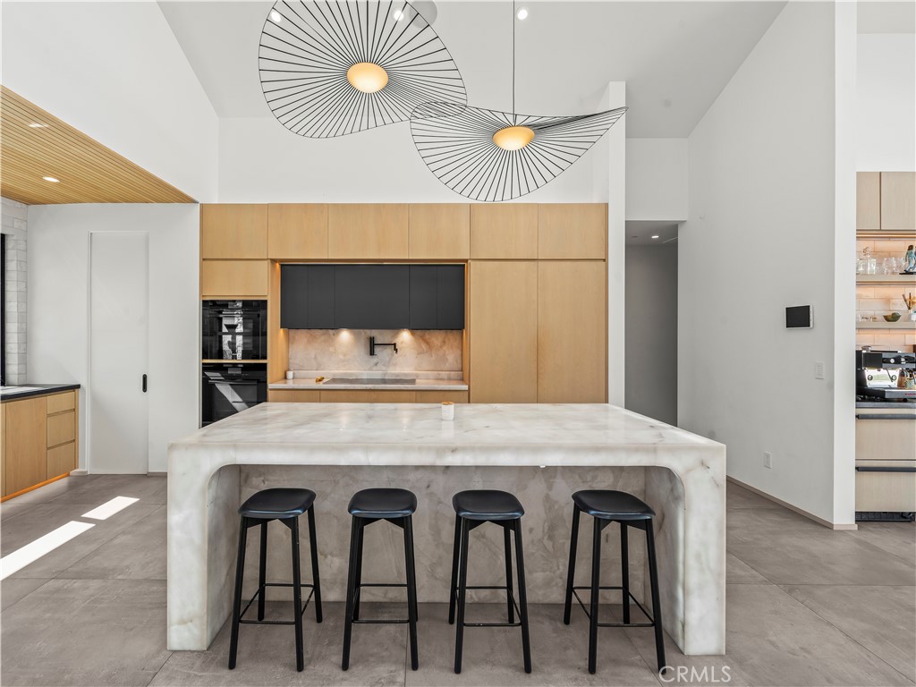 4874 Sun Valley Road Del Mar, CA 92014 - Photo 12 of 15 a dining table with chairs and table