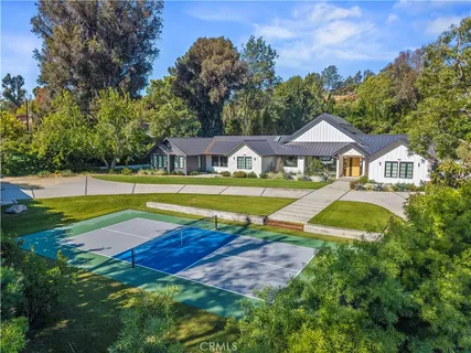 a view of an house with swimming pool and yard