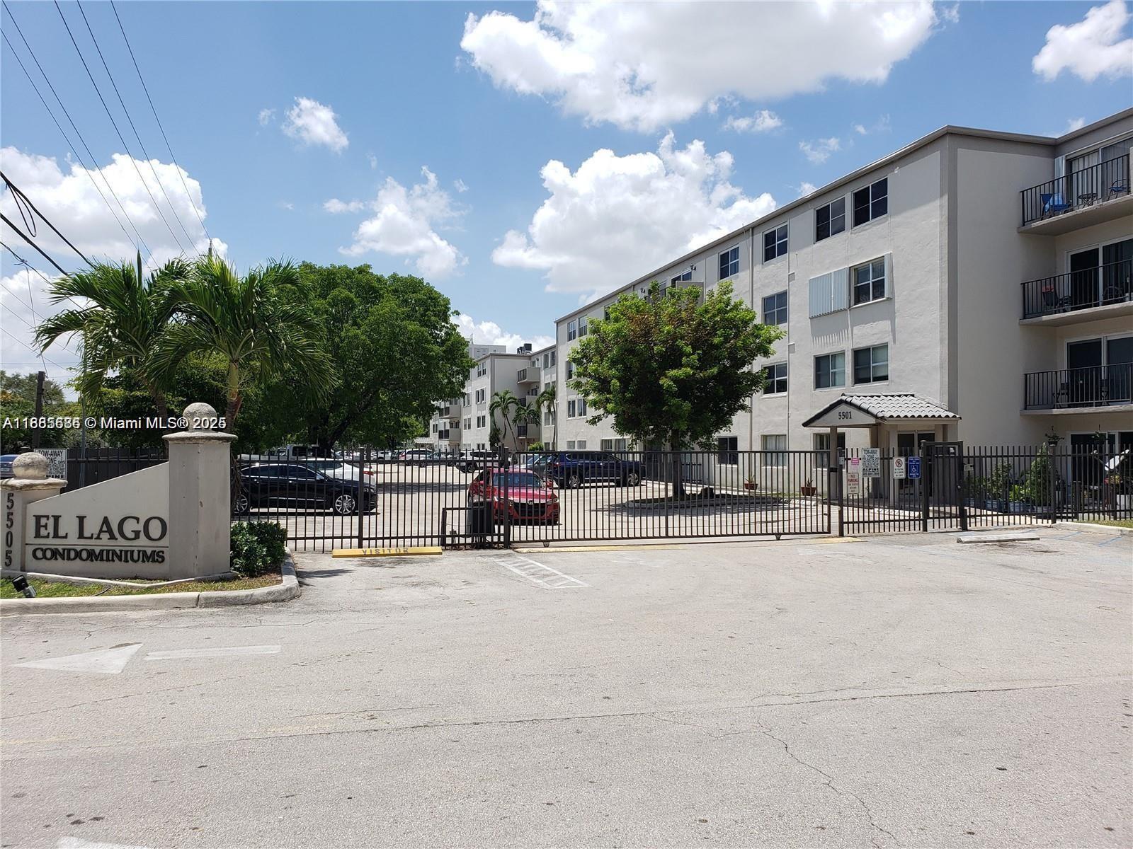 5505 Northwest 7th Street, Unit W219 Miami, FL 33126 - Photo 2 of 9 a row of table and chairs in front of building