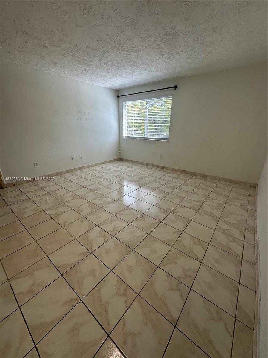 5505 Northwest 7th Street, Unit W219 Miami, FL 33126 - Photo 5 of 9 a view of a room and window