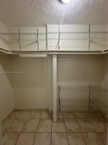 a view of storage and utility room with racks on the wall