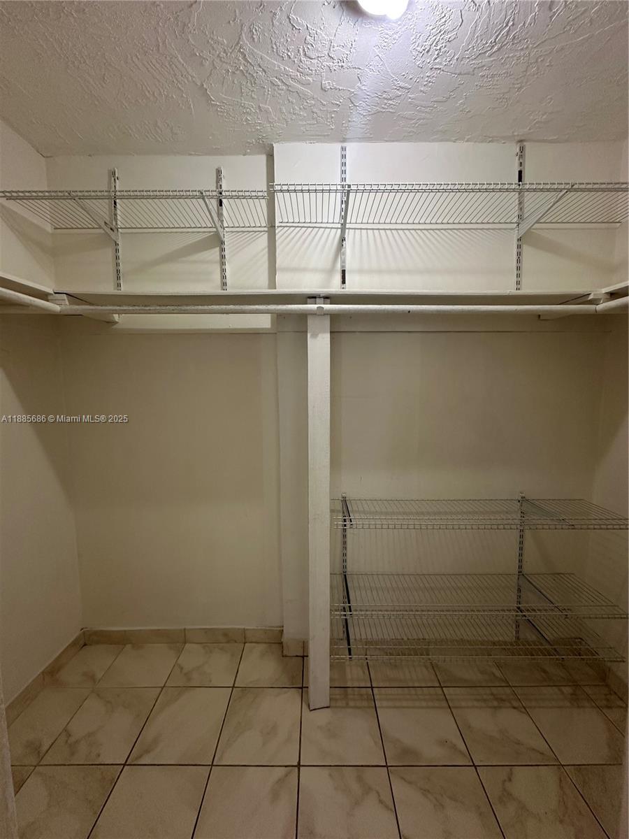 5505 Northwest 7th Street, Unit W219 Miami, FL 33126 - Photo 8 of 9 a view of storage and utility room with racks on the wall