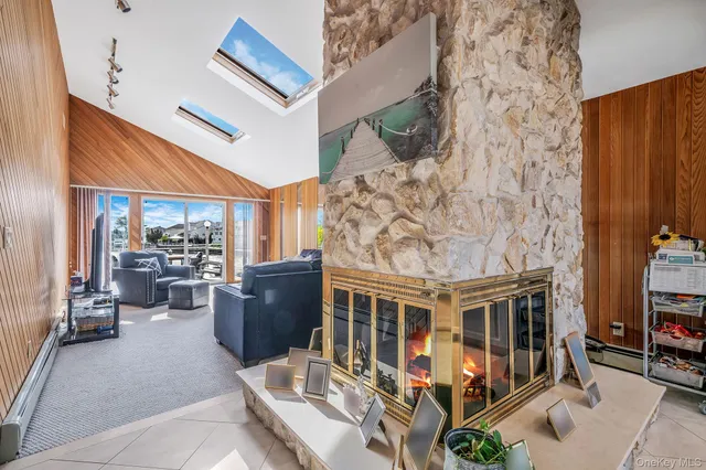 a living room with a large window and a book shelf