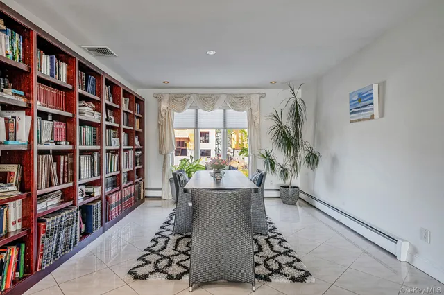 a kitchen with kitchen island granite countertop a table chairs microwave and cabinets