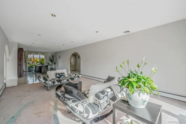 a bathroom with a granite countertop double vanity sink a mirror and a bathtub