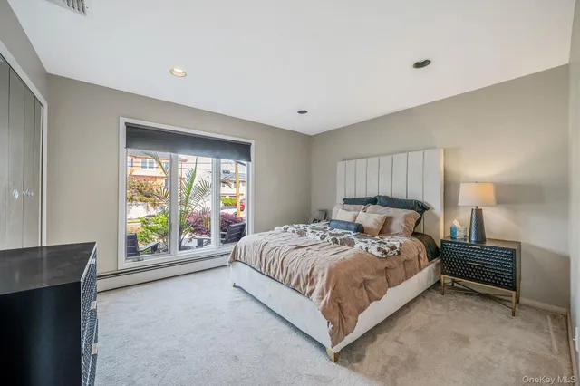a living room with a bed furniture and a ceiling fan