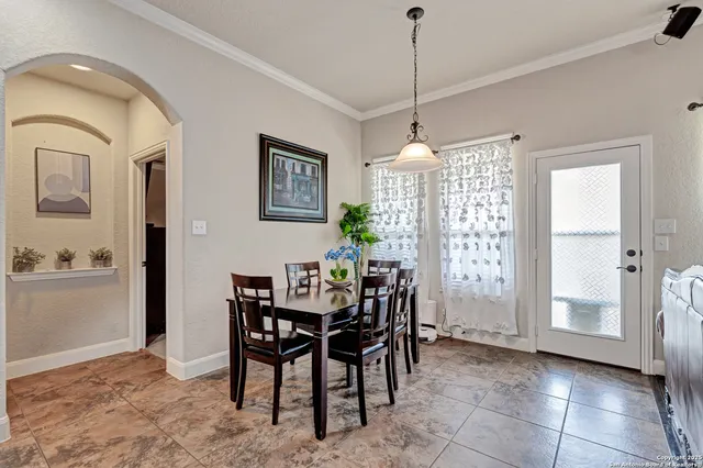 a view of a dining room with furniture and window