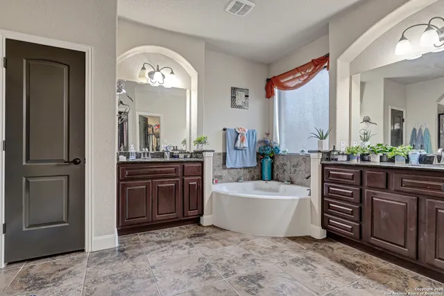 a spacious bathroom with a double vanity sink and a mirror