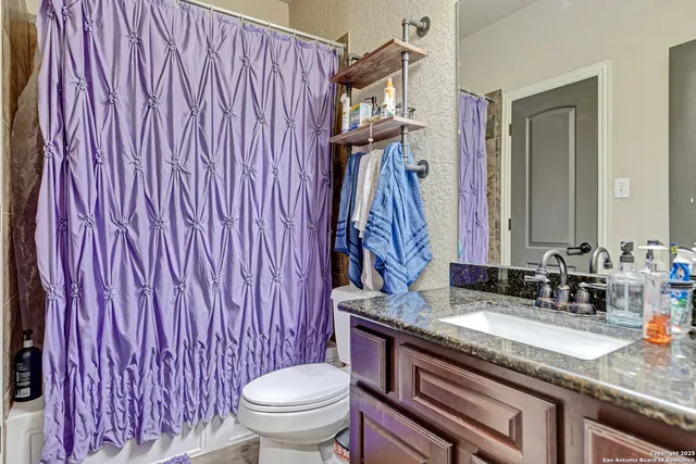 a living room with lots of furniture and white walls