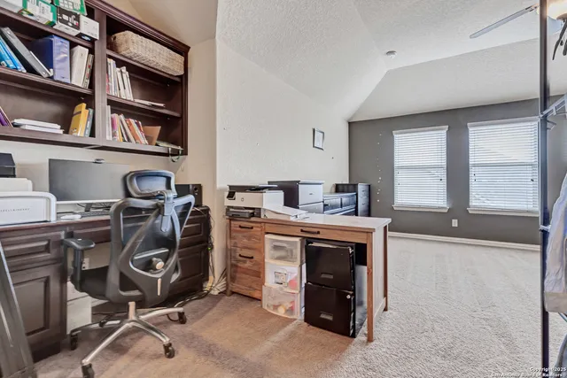 a spacious bedroom with a bed and a chandelier