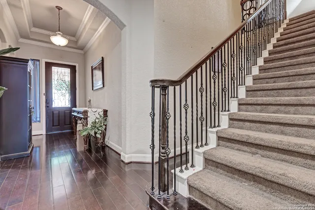 a view of entryway and hall with wooden floor