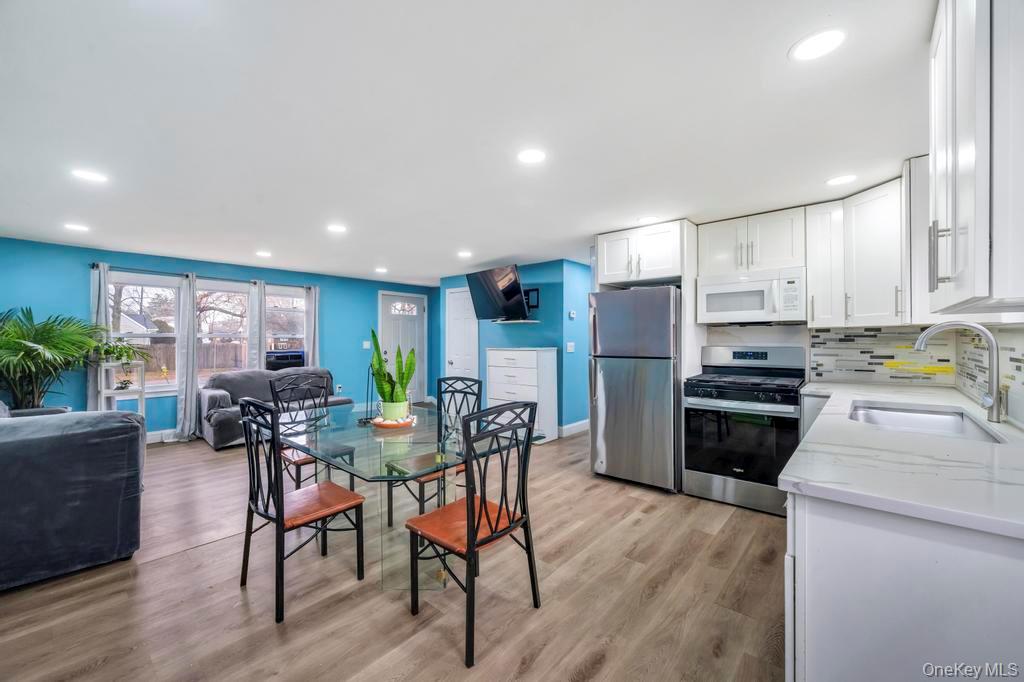 19 Windus Road Shirley, NY 11967 - Photo 12 of 29 a view of kitchen with refrigerator stove dining table and chairs