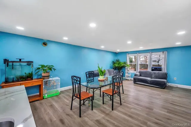 a view of a dining room with furniture window and wooden floor