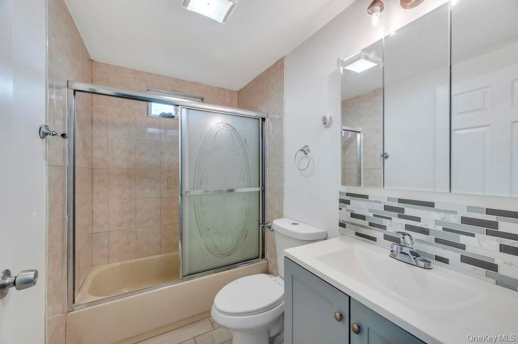 19 Windus Road Shirley, NY 11967 - Photo 16 of 29 a bathroom with a sink a toilet and shower