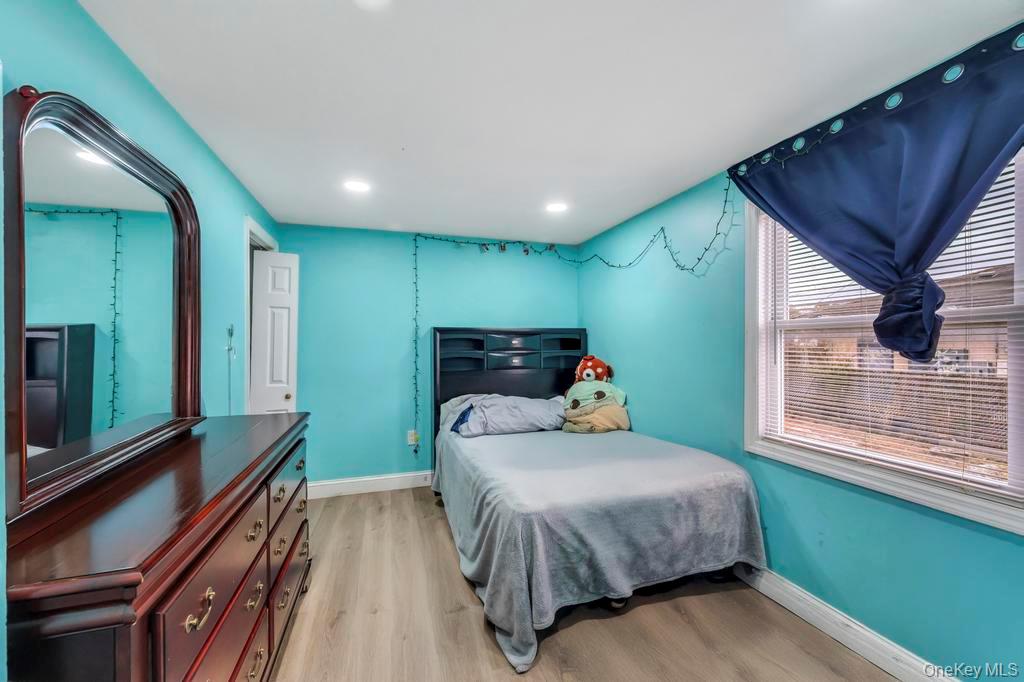 19 Windus Road Shirley, NY 11967 - Photo 17 of 29 a bedroom with a bed next to a window