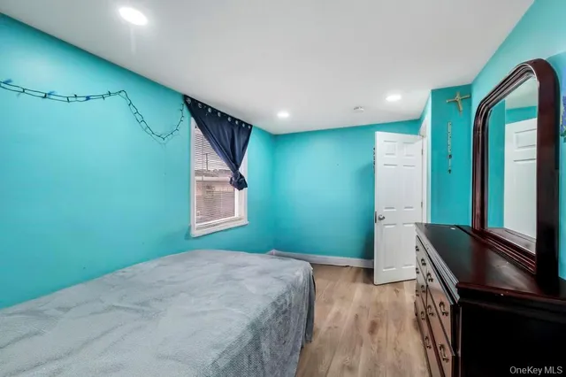 a bedroom with a bed and a dresser