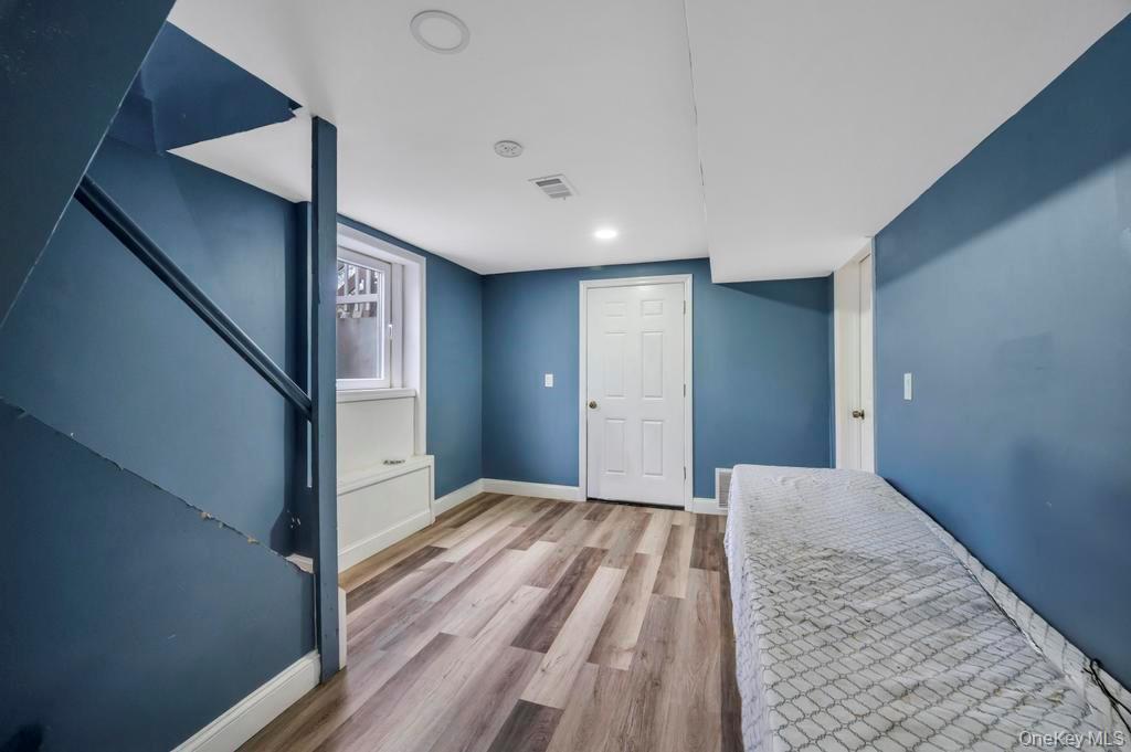 19 Windus Road Shirley, NY 11967 - Photo 22 of 29 a view of hallway with wooden floor and stairs