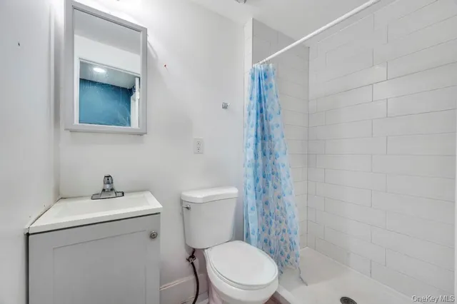 a bathroom with a toilet sink and shower