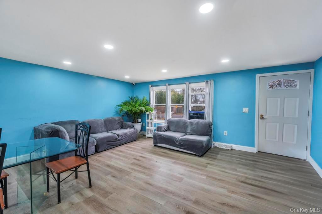 19 Windus Road Shirley, NY 11967 - Photo 6 of 29 a living room with furniture and wooden floor