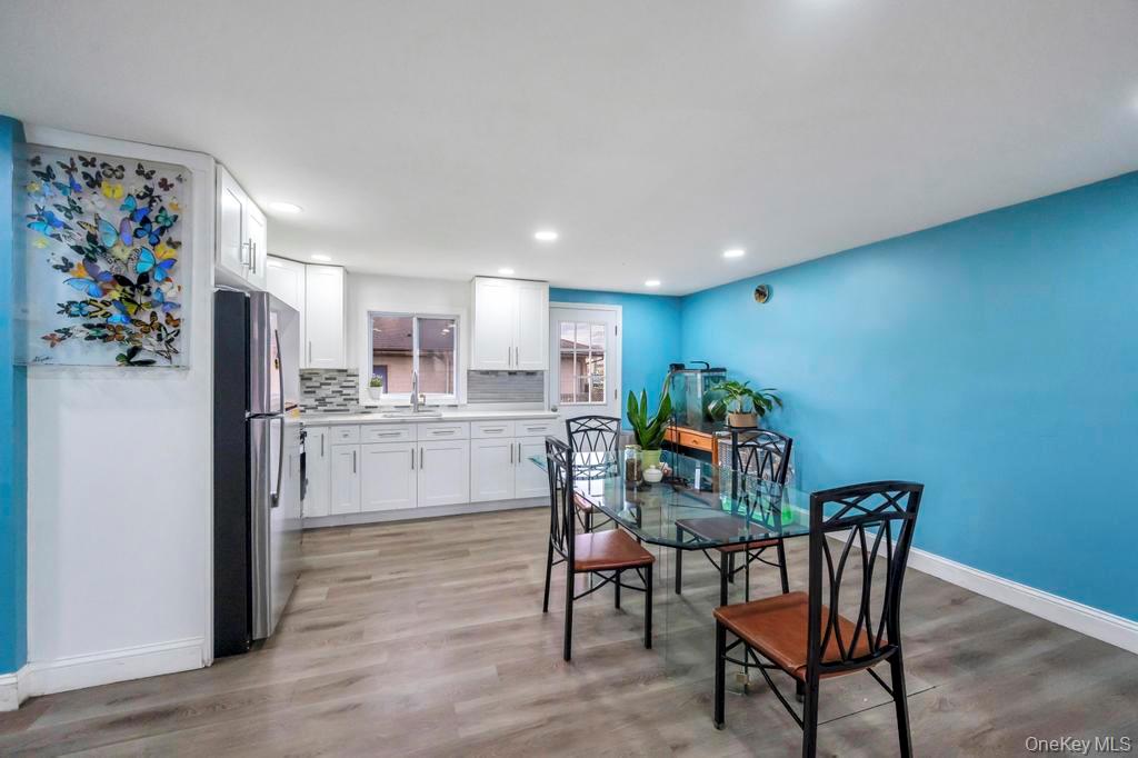 19 Windus Road Shirley, NY 11967 - Photo 10 of 29 a kitchen with white cabinets and stainless steel appliances