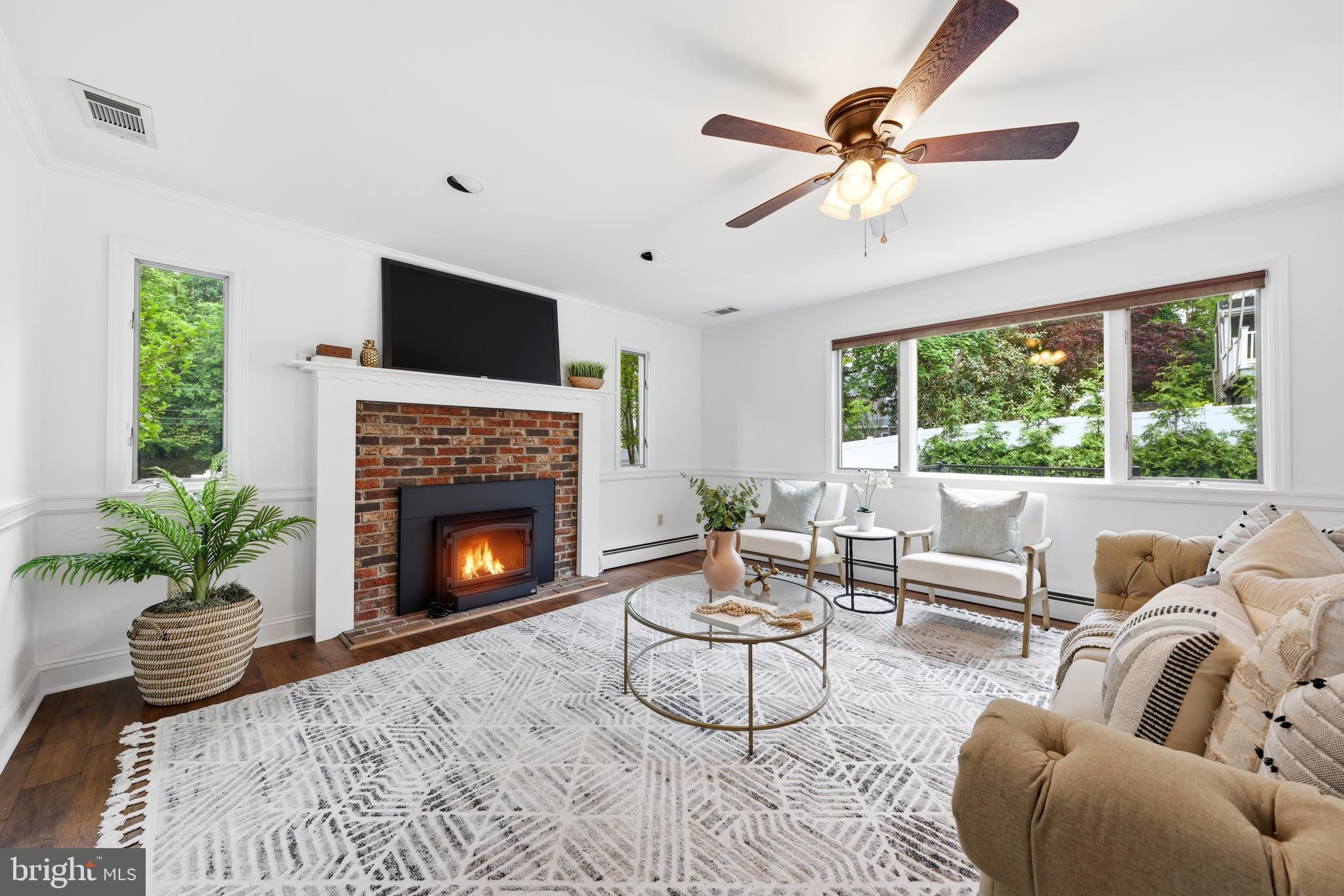 404 Centre Street Haddonfield, NJ 08033 - Photo 13 of 38 a living room with furniture a fireplace and a floor to ceiling window