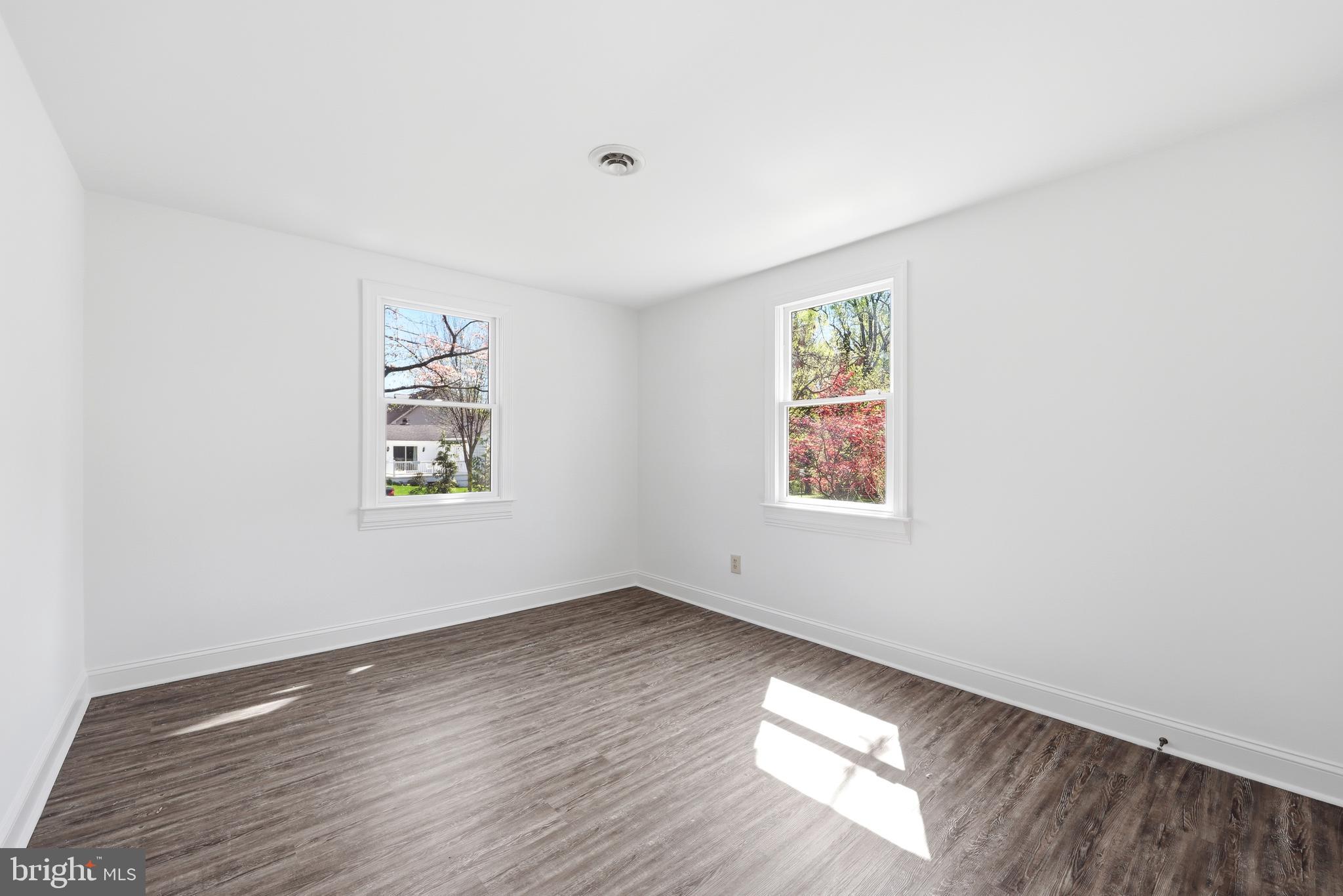 404 Centre Street Haddonfield, NJ 08033 - Photo 18 of 38 an empty room with wooden floor and windows