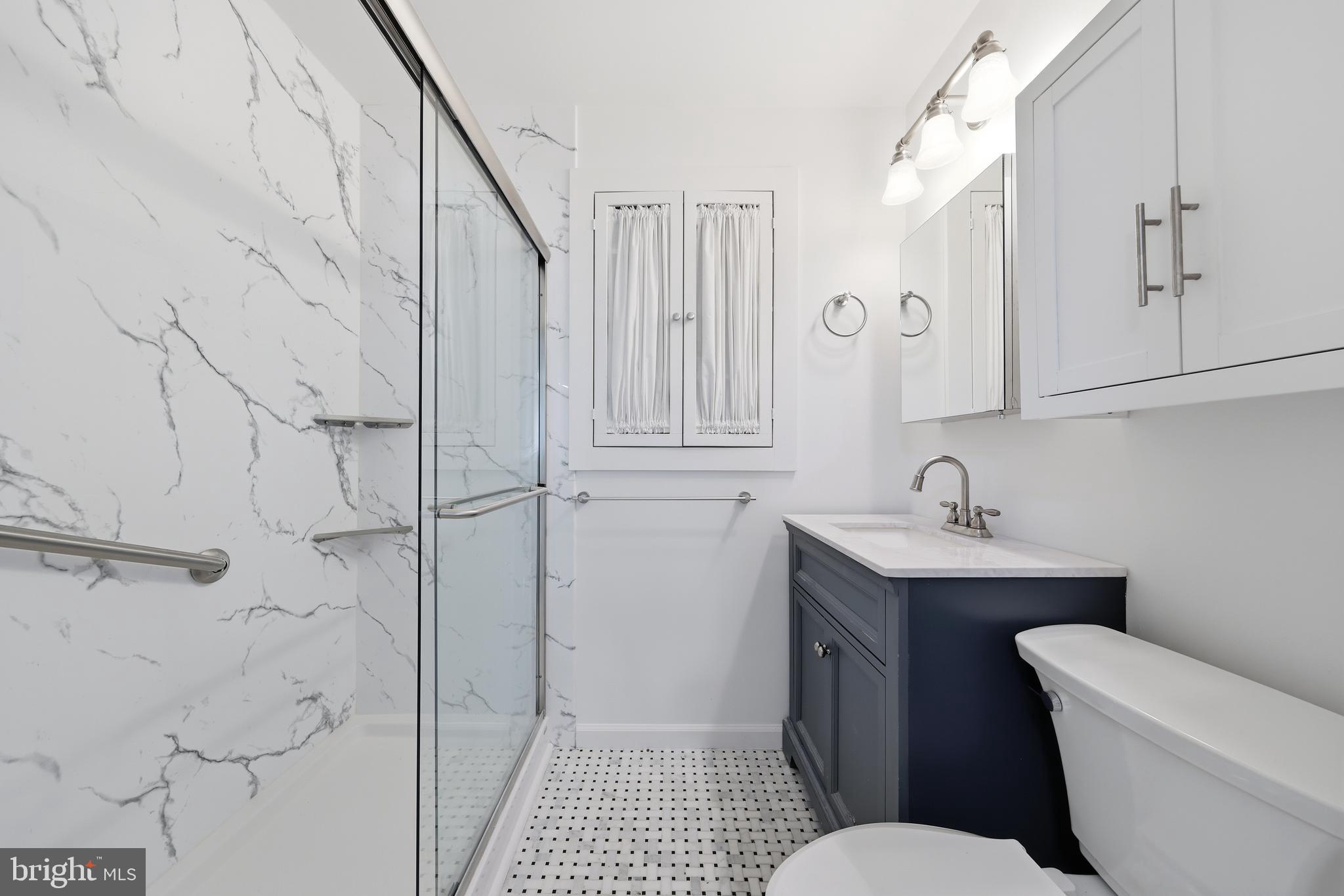 404 Centre Street Haddonfield, NJ 08033 - Photo 19 of 38 a bathroom with a toilet sink and shower