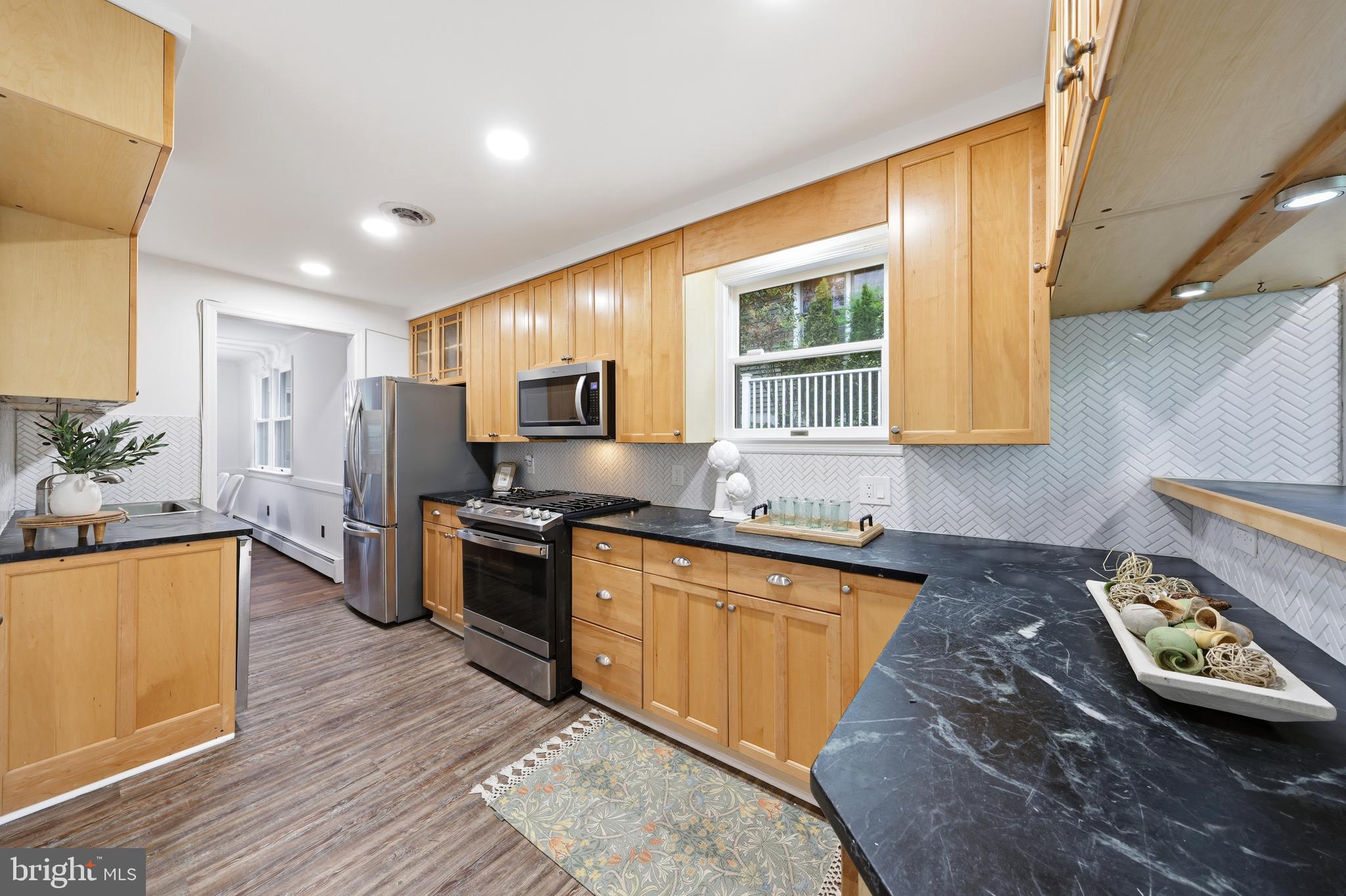 404 Centre Street Haddonfield, NJ 08033 - Photo 7 of 38 a kitchen with stainless steel appliances granite countertop a stove a sink dishwasher and a refrigerator