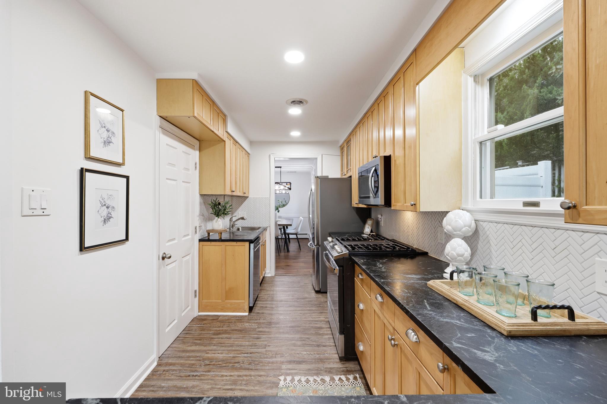 404 Centre Street Haddonfield, NJ 08033 - Photo 8 of 38 a kitchen with stainless steel appliances granite countertop a stove and a sink