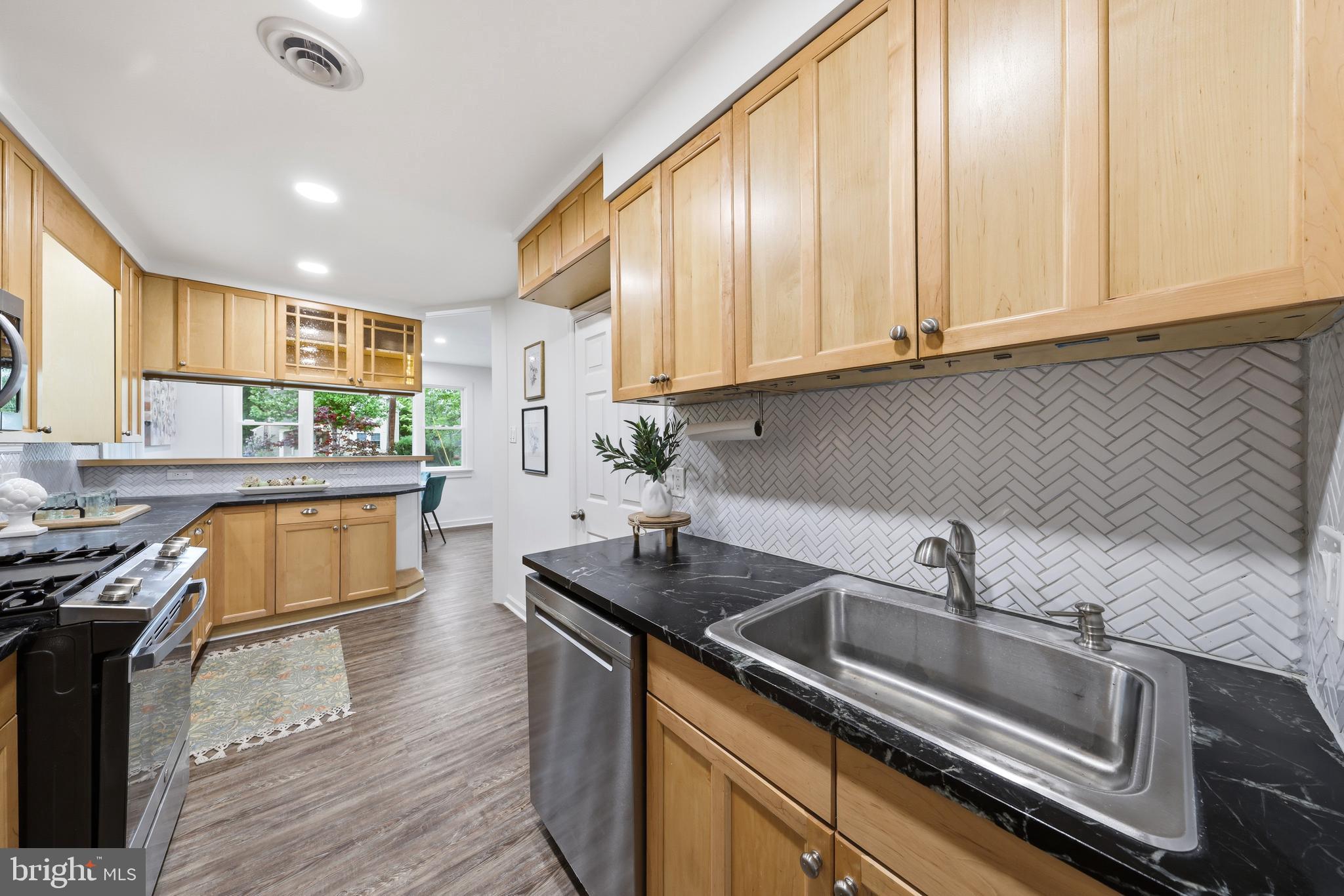 404 Centre Street Haddonfield, NJ 08033 - Photo 10 of 38 a kitchen with stainless steel appliances granite countertop a sink stove and cabinets