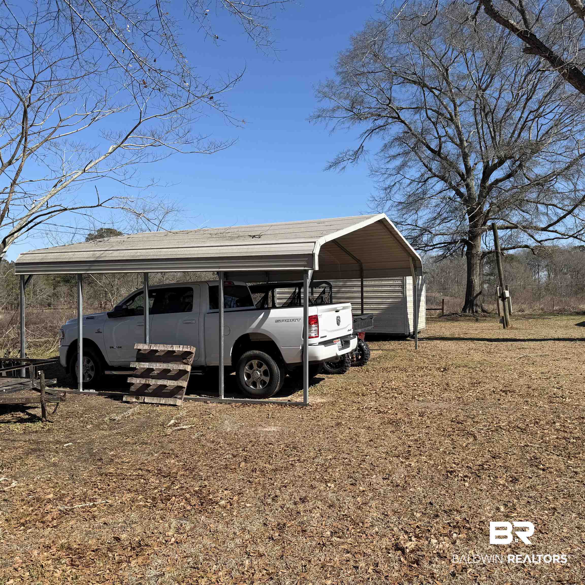 447 Sugar Hill Road Monroeville, AL 36460 - Photo 27 of 27 View of parking with a detached carport