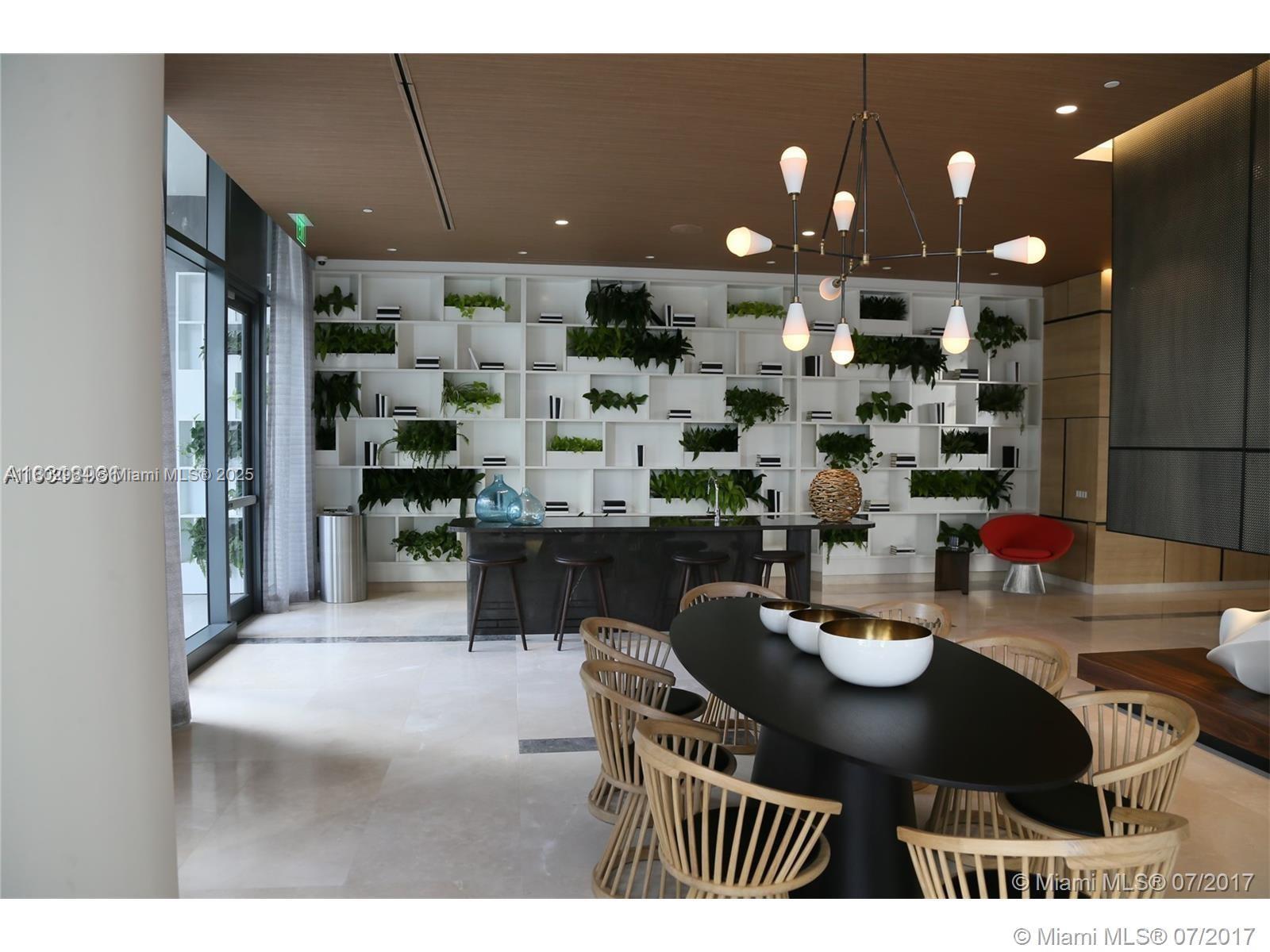55 Southwest 9th Street, Unit 3409 Miami, FL 33130 - Photo 17 of 28 a kitchen with a table and chairs