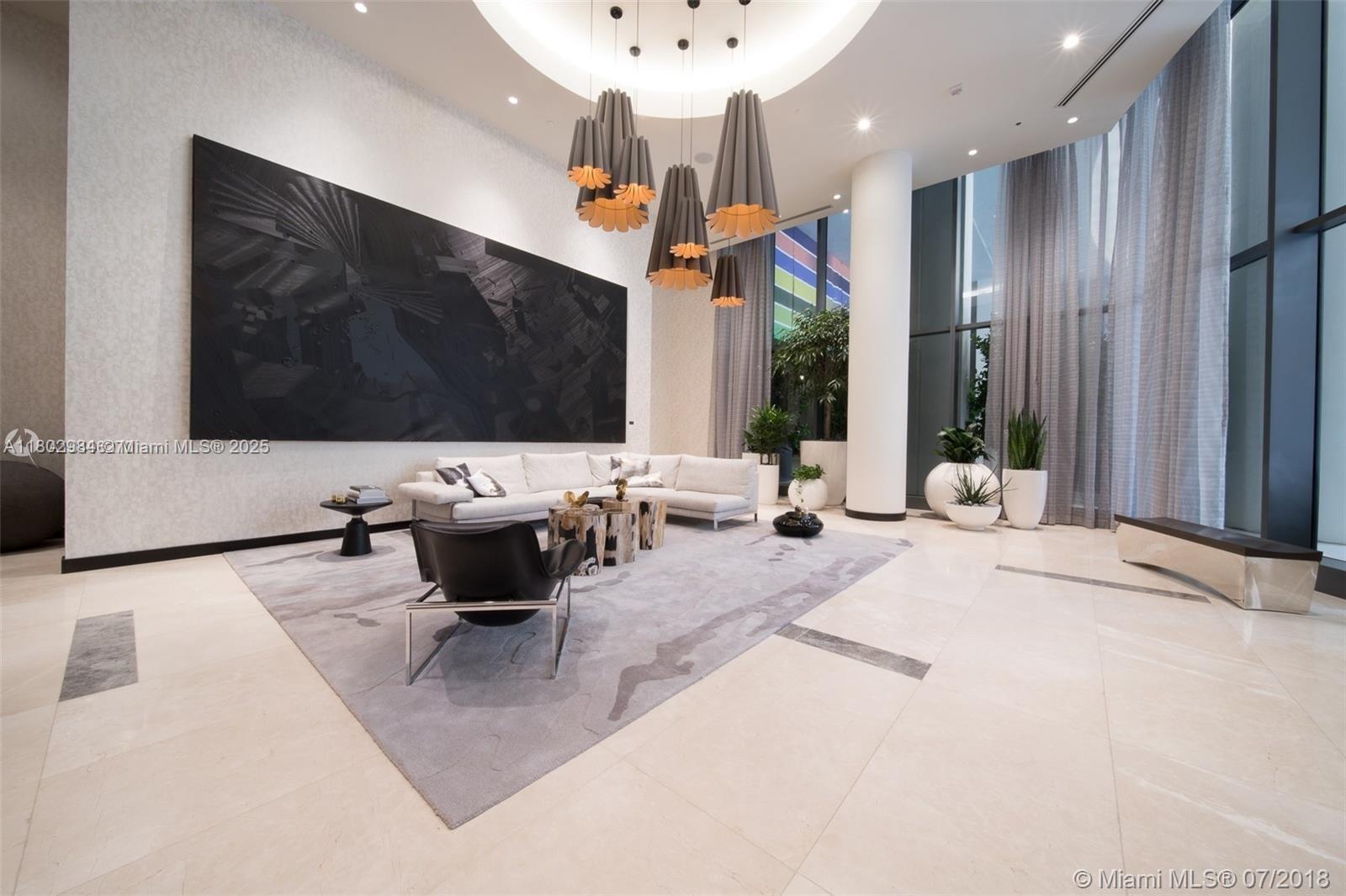 55 Southwest 9th Street, Unit 3409 Miami, FL 33130 - Photo 20 of 28 a living room with patio furniture and a flat screen tv