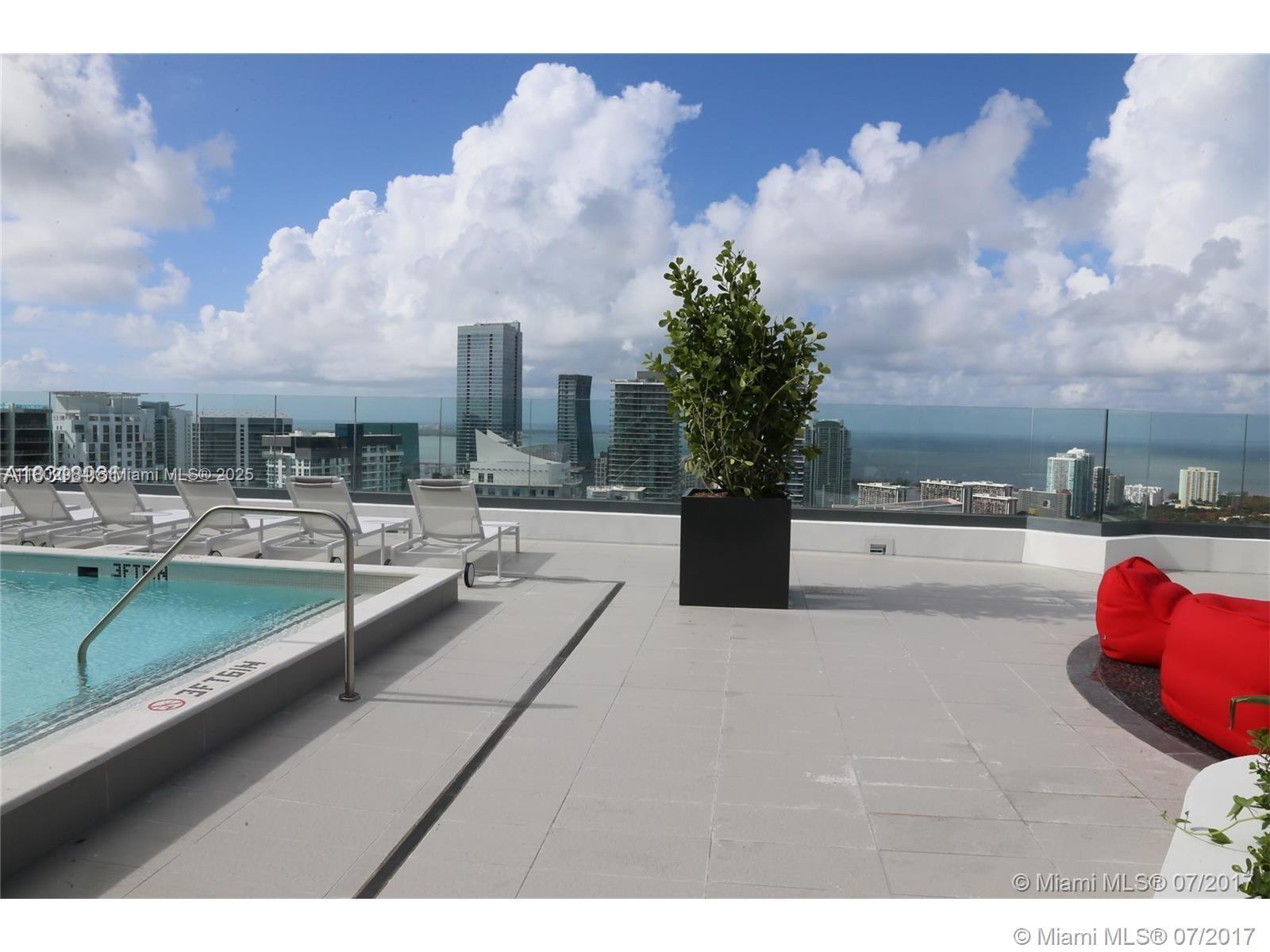 55 Southwest 9th Street, Unit 3409 Miami, FL 33130 - Photo 22 of 28 a view of swimming pool outdoor seating and living room